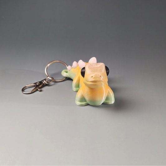 Dinozaura (ar dzeloņu) atslēgu piekariņš